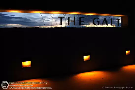 City Of Lethbridge, Galt Museum at night. The sign outside the museum lit from behind with the setting sun.