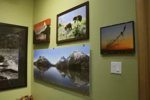 Massive panoramic photograph mounted on a wall surrounded by other prints at First Choice Photo Lethbridge