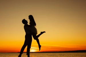 Couple at a beach with a sunset